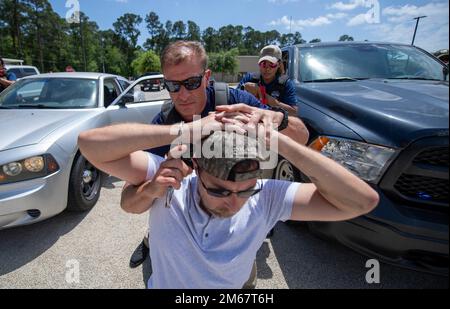 ICE Enforcement and Removal Operations (ERO) deportation officers conduct the simulated arrest of a suspect during vehicle-stop training at the Federal Law Enforcement Training Center (FLETC) in Glencoe Georgia on April 13, 2022. Stock Photo