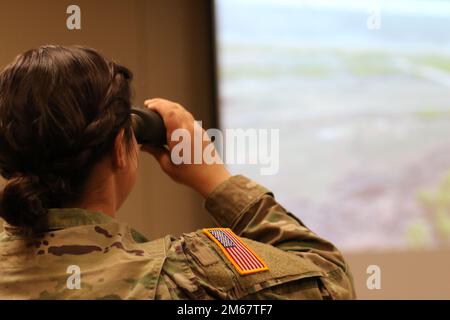 A soldier assigned to 704th Brigade Support Battalion, 2nd Stryker Brigade Combat Team, 4th Infantry Division used the call for fire trainer on Fort Carson, Colo., April 14, 2022.  The call for fire trainer allows soldiers to learn how to and practice calling for artillery fires on enemy targets. U.S. Army photo by Maj. Jason Elmore. Stock Photo