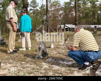 Mr. Bob Carter, Greensboro, NC, studies a headstone of an ancestor in the Green Bay Cemetery April 14.    Fort Stewart hosted the installation’s spring cemetery tour April 14.    Nearly 20 participants visited two of the installation’s over 50 cemeteries, with stops at Green Bay and Wells cemeteries. Stock Photo