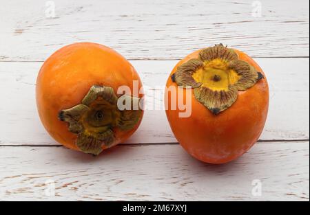 Fresh ripe persimmons isolated on white background Stock Photo