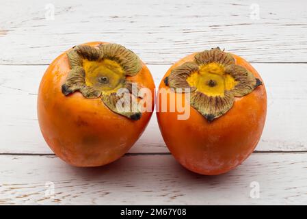 Fresh ripe persimmons isolated on white background Stock Photo