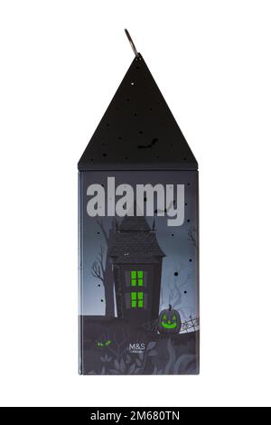 Halloween tin isolated on white background - all butter biscuit light up lantern with a creepy green LED tea light from M&S Stock Photo
