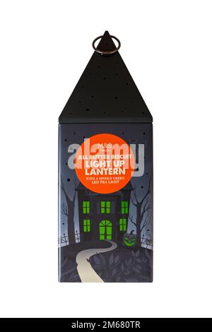 Halloween tin isolated on white background - all butter biscuit light up lantern with a creepy green LED tea light from M&S Stock Photo