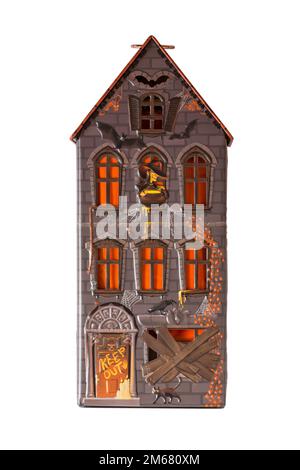 Halloween tin isolated on white background - all butter biscuit light up house with a creepy orange LED tea light from M&S Stock Photo