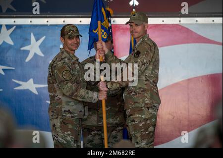 Lt. Col. Jonathan Barber, right, outgoing 4th Operational Support Squadron commander, relinquishes the guidon to Col. Michael Alfaro, 4th Operations Group commander, during the 4th OSS change of command ceremony at Seymour Johnson Air Force Base, North Carolina, April 15, 2022. The passing of a unit's guidon symbolizes a transfer of command. Stock Photo