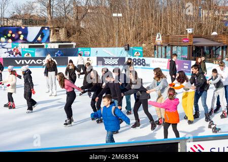 Teenagers having fun at an outdoor ice skating rink in Sofia, Bulgaria, Eastern Europe, Balkans, EU Stock Photo