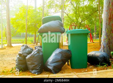 overflowing green wheelie bin Stock Photo