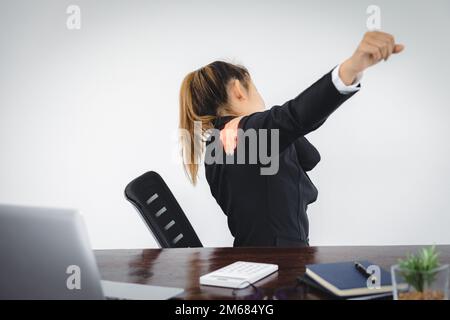 Businesswoman Suffering From Shoulder Pain At Workplace. Stock Photo