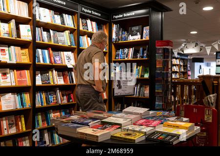 A male customer browsing in a Waterstones Bookshop Bookstore. Stock Photo