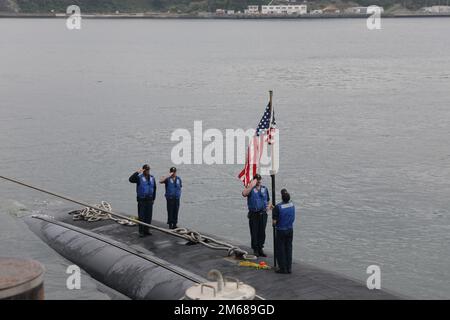 YOKOSUKA, Japan (April 18, 2022) Sailors from the Los Angeles-class fast-attack submarine USS Alexandria (SSN 757) salute the ensign after arriving at Fleet Activities Yokosuka for a scheduled port visit, April 18, 2022. Alexandria is homeported in San Diego and routinely operates in the U.S. 7th Fleet area of operations, conducting maritime security operations and supporting national security interests. Stock Photo