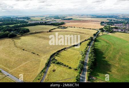 Durrington Walls. Site of major prehistoric Neolithic settlement and henge enclosure 3 km N.E. of Stonehenge. Aerial view to N.W. Dry summer condition Stock Photo