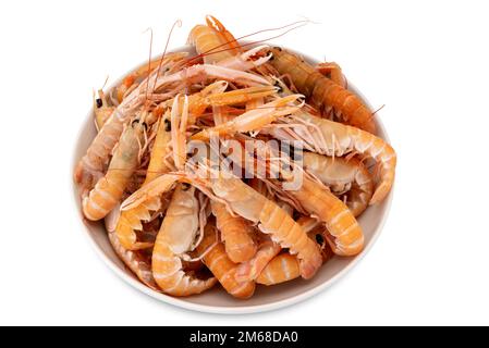 Langoustines, raw scampi in white dish ready to be cooked,  isolated on white, top view with clipping path Stock Photo