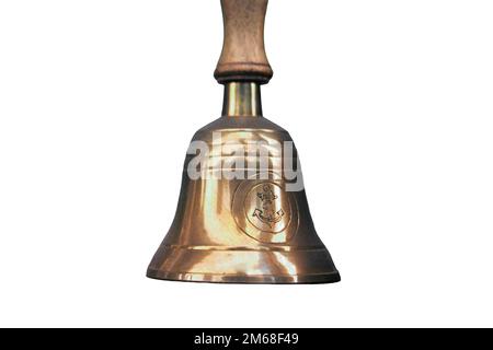Old ship hand bell made of yellow metal with an anchor pattern, isolated on a white background Stock Photo