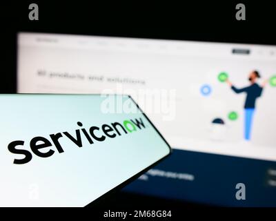 Cellphone with logo of American software company ServiceNow Inc. on screen in front of business website. Focus on left of phone display. Stock Photo