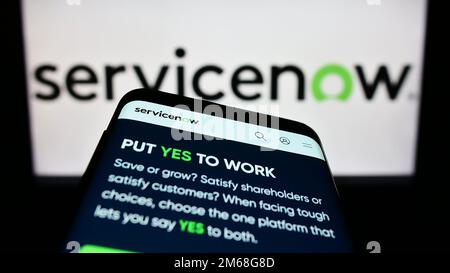Mobile phone with website of US software company ServiceNow Inc. on screen in front of business logo. Focus on top-left of phone display. Stock Photo
