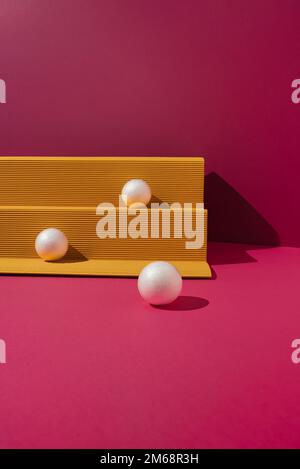Yellow paper podium with white balls on magenta background. Minimal concept. Stock Photo