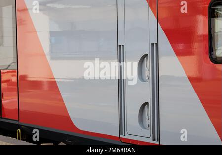 train car with closed doors at the station. red modern high speed passenger train Stock Photo