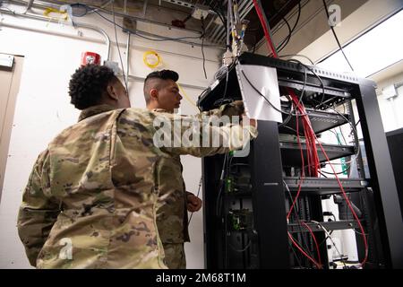 Airman 1st Class Savannah Wilson, 608th Air Communications Squadron radio frequency technician, and Airman 1st Class Tyler Fajardo, 608th ACOMS radio frequency technician, perform a radio check and network test in the 8th Air Force attic. These tests ensure two-way communication is seamless in a time of need. 8th Air Force,AFGSC,Barksdale Air Force Base,Joint-Global Strike Operations Center,communications, Stock Photo