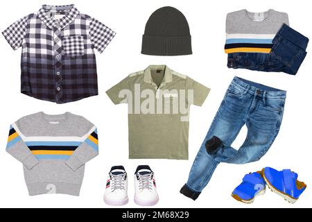 Collage set of little boys spring clothes isolated on a white background. Denim trousers or pants, a pair of shoes, sneaker, cap, shirts and jumpers f Stock Photo