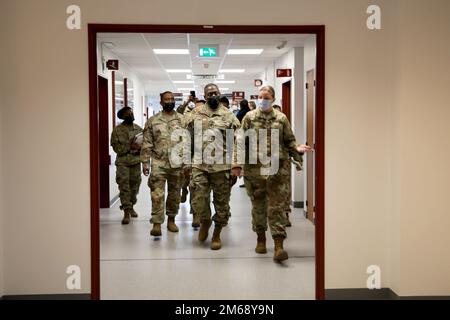 Maj Holly R. Archer, right, deputy commander of nursing, leads a tour of SHAPE Healthcare Facility with Lt. Gen. R. Scott Dingle, center, surgeon general of the Army and Medical Command commanding general, and MEDCOM Command Sgt. Maj. Diamond D. Hough, left foreground, April 20, 2022 at Casteau, Belgium. Stock Photo