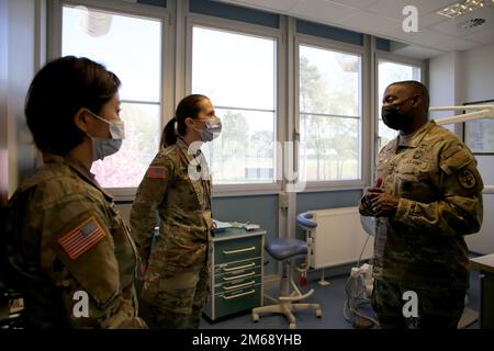 Lt. Gen. R. Scott Dingle, right, surgeon general of the Army and Medical Command commanding general, tours SHAPE Dental Clinic with Maj Autumn L. Becker, center, commander of SHAPE Dental Clinic, and Staff Sgt. Yang Z. Bautista, left, dental assistant, April 20, 2022 at SHAPE Healthcare Facility in Casteau, Belgium. Stock Photo