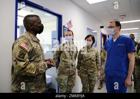 Lt. Gen. R. Scott Dingle, left, surgeon general of the Army and Medical Command commanding general, presents a coin at SHAPE Dental Clinic to Maj. Daniel D. Becker, right, dentist, April 20, 2022 at SHAPE Healthcare Facility in Casteau, Belgium. Stock Photo