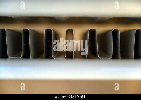 View of a home double panel convector radiator (or heat convector) seen from above. Shallow depth of field focusing on the internal convector fins. Stock Photo