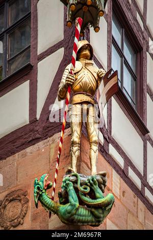 Knight and Dragon - Mediaeval decoratian on house's corner in Nuremberg, Germany Stock Photo