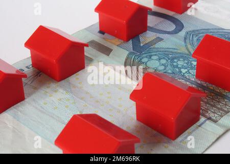 Red houses and banknotes Stock Photo