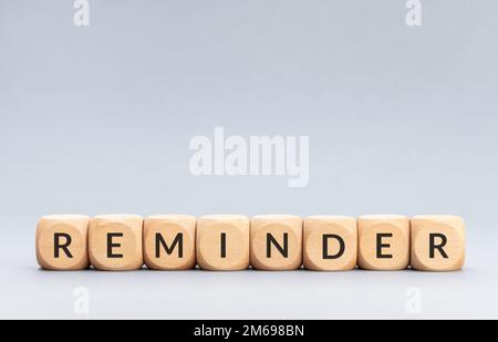 Reminder word on wooden blocks on gray background. Copy space Stock Photo