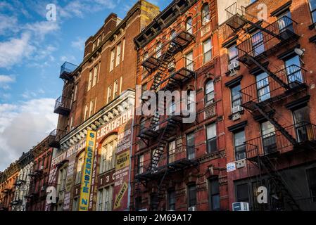 Historical buildings with fire escape stairs, The Bowery, a historic neighbourhood  in the Lower East Side of Manhattan, New York City, USA Stock Photo