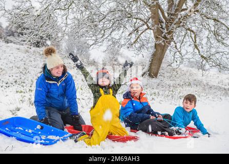 Sledging fun in the Cotswolds near Wotton-under-Edge Stock Photo