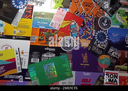 A mix of UK craft beer labels, stuck to a wall, as wallpaper Stock Photo