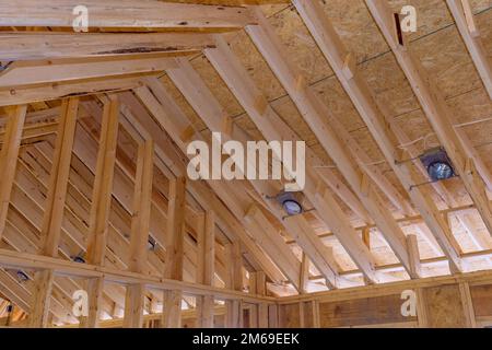 Mounted spot lamp light to into ceiling install the lighting lamp in new home construction and wood beam framework Stock Photo
