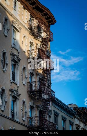 Historical buildings with fire escape stairs, The Bowery, a historic neighbourhood  in the Lower East Side of Manhattan, New York City, USA Stock Photo