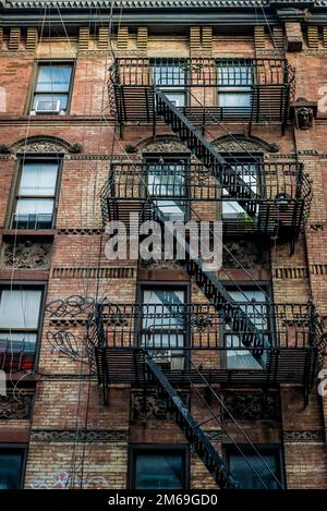 Historical buildings with fire escape stairs, The Bowery, a historic neighbourhood  in the Lower East Side of Manhattan, New York City, USA Stock Photo