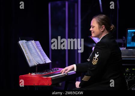 PITTSBURGH (April 20, 2022)  Senior Chief Musician Caroline Evans, from Flagstaff, Arizona, plays piano during a 'Music in the Schools' concert  at the Pittsburgh Creative and Performing Arts magnet high school. The United States Navy Band Sea Chanters chorus  performed in seven states during its 13-city, 2,000-mile tour, connecting communities across the nation to their Navy. Stock Photo
