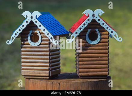 Nesting box. Carved wooden nest box handmade. Wooden house for birds Stock Photo