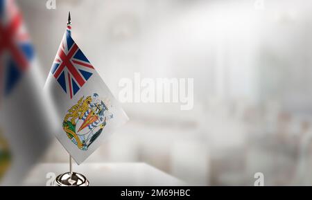 Small flags of the British Antarctic Territory on an abstract blurry background. Stock Photo