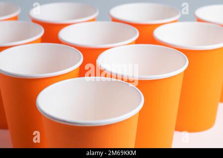 large group of orange disposable paper cups. Stock Photo