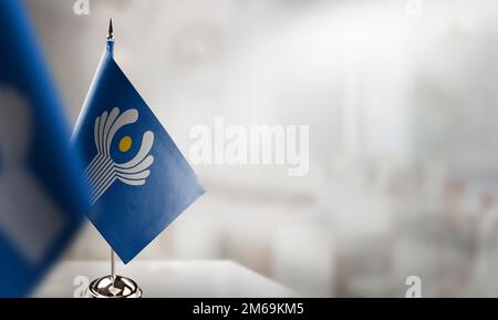 Small flags of the CIS on an abstract blurry background. Stock Photo