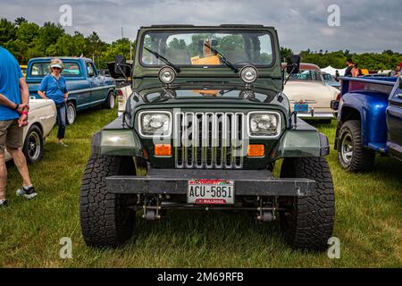Iola, WI - July 07, 2022: High perspective front view of a 1991 Jeep Wrangler YJ at a local car show. Stock Photo