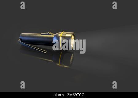 battery-powered flashlight on a black background Stock Photo
