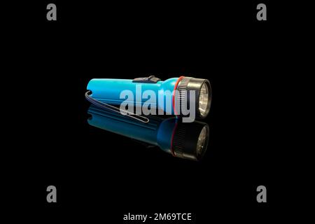 battery-powered flashlight on a black background Stock Photo