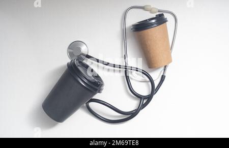 stethoscope and takeaway coffee on a white background. Stock Photo