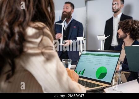 Business people working together on sustainable innovation project - Green renewable energy concept - Focus on laptop Stock Photo