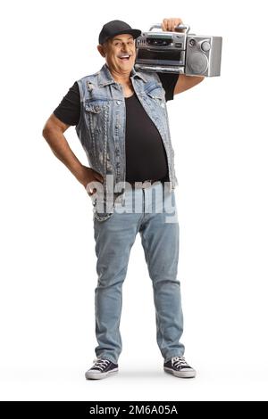 Cheerful mature man standing and holding a boombox radio on his shoulder isolated on white background Stock Photo