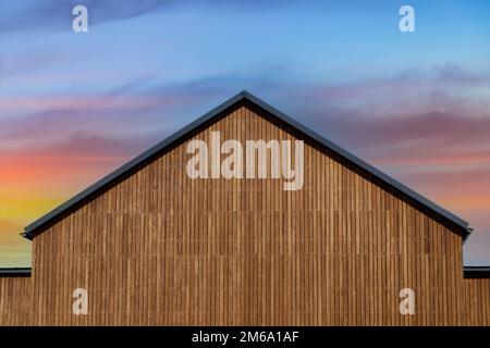 The roof of a new modern house in a minimalist style with natural wood plank facade decoration. Copy space Stock Photo