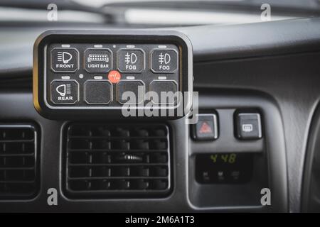 Third-party control panel in the car interior to control external mounted additional lighting. Car light tuning Stock Photo