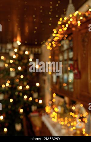 Blurred Portrait Christmas Impression with Decorated Cupboard, Fairy Lights and Christmas Tree Stock Photo